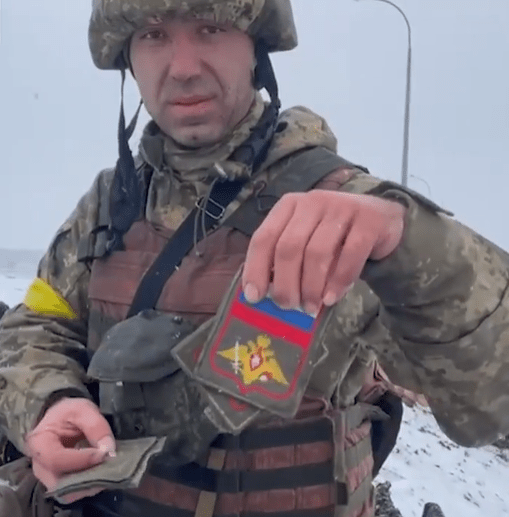A Brave Sun Man Takes Cover From Russian Shells Exploding On The Front Line As A Ukrainian Soldier Displays The Trophies Of His Dead Enemies Ukrainian Soldier Showed Stripes Of Killed Russian Servicemen