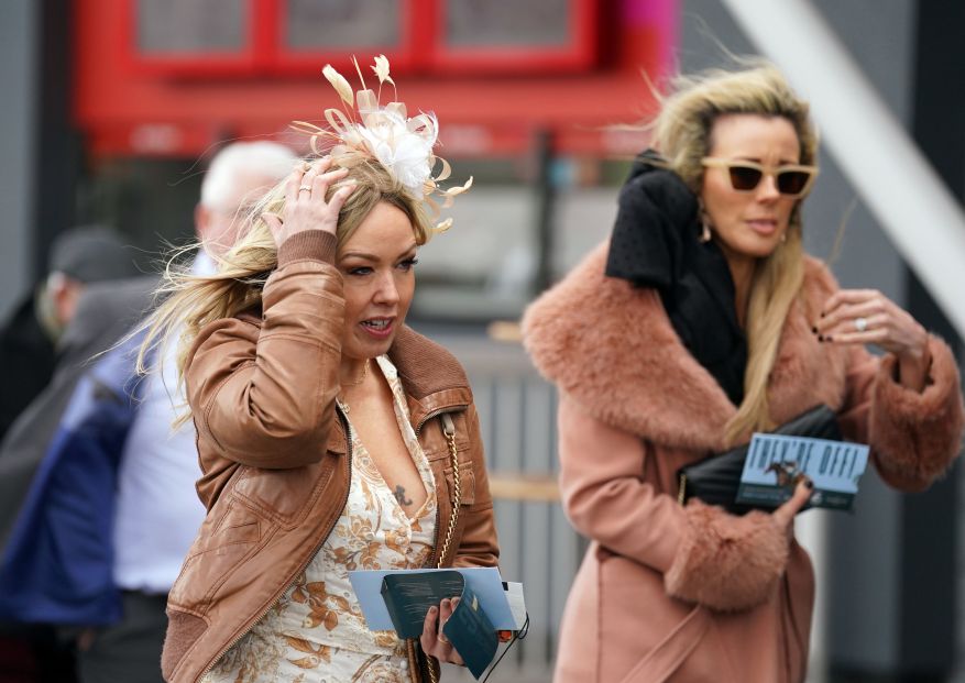 Aintree Revelers Get Into The Party Spirit At The Grand National As Racers Enjoy Booze And Plucky Frosts. Visitors Cling To Their Sorcerers As They Come To The Course