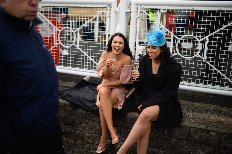 Aintree Revelers Get Into The Party Spirit At The Grand National As Racers Enjoy Booze And Plucky Frosts. The Two Friends Beamed As They Rested Their Aching Feet