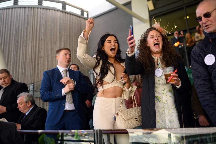 Aintree Revelers Get Into The Party Spirit At The Grand National As Racers Enjoy Booze And Plucky Frosts. The Races Took Place For The First Time In Two Years Since The Impact Of Covid.